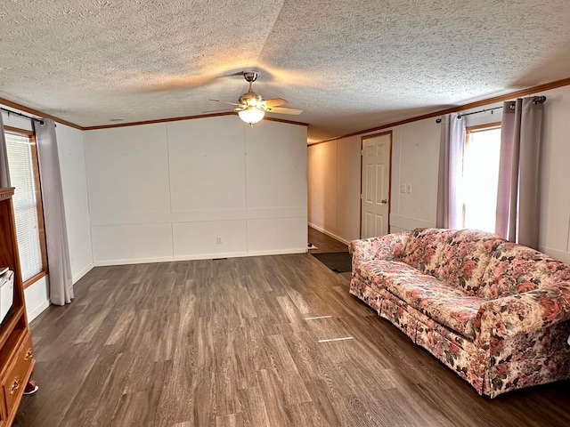 33363 Gardenview Dr, Sturgeon Lake, MN 55783 - living area with dark wood-type flooring, crown molding, a ceiling fan, a textured ceiling, and baseboards