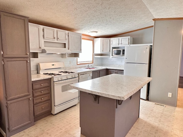 33363 Gardenview Dr, Sturgeon Lake, MN 55783 - kitchen with white appliances, a sink, a textured ceiling, tasteful backsplash, and light countertops