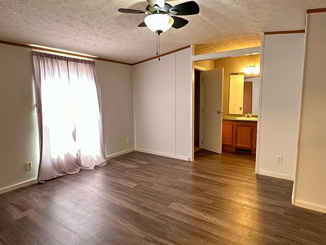 33363 Gardenview Dr, Sturgeon Lake, MN 55783 - empty room featuring a textured ceiling, ceiling fan, dark wood-style flooring, crown molding, and baseboards