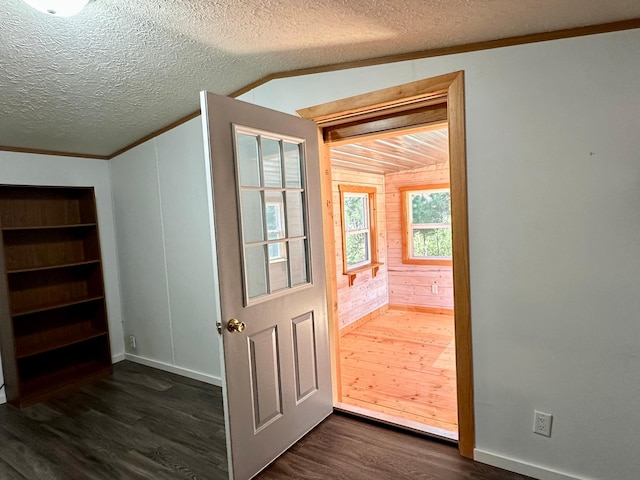 33363 Gardenview Dr, Sturgeon Lake, MN 55783 - doorway featuring dark wood finished floors, vaulted ceiling, ornamental molding, a textured ceiling, and wood walls