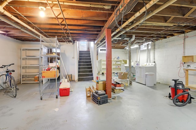 unfinished below grade area featuring washer and dryer and stairway