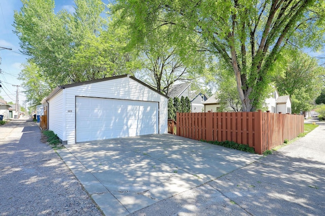 detached garage featuring fence