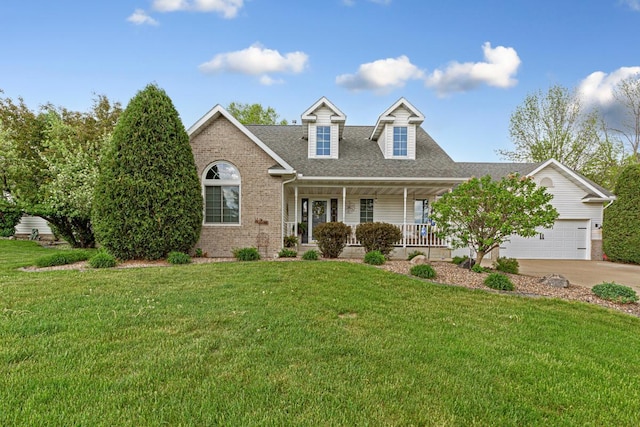 view of front of home featuring brick siding, a porch, driveway, and a front lawn