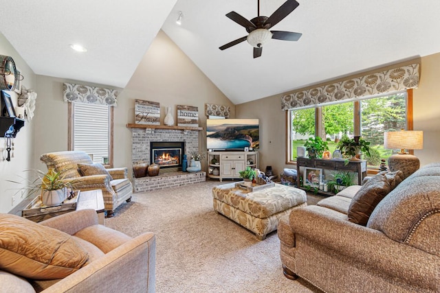 carpeted living area with a ceiling fan, high vaulted ceiling, and a brick fireplace