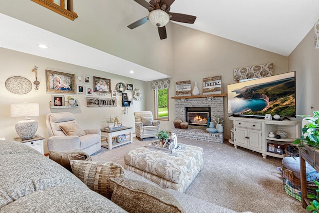 carpeted living area with ceiling fan, a brick fireplace, high vaulted ceiling, and recessed lighting