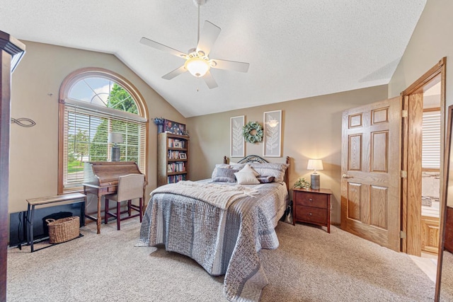 bedroom featuring carpet floors, vaulted ceiling, a textured ceiling, and a ceiling fan
