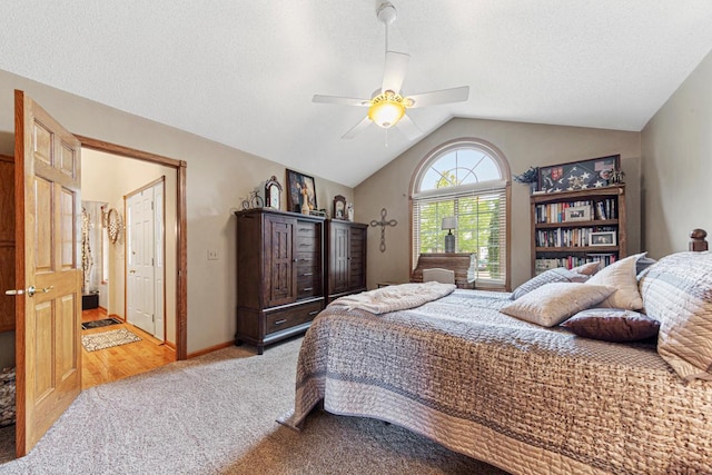 carpeted bedroom with vaulted ceiling and ceiling fan