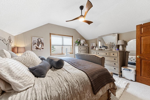 bedroom featuring light carpet, ceiling fan, vaulted ceiling, and a textured ceiling