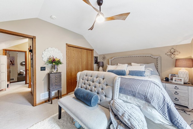 bedroom featuring vaulted ceiling, light carpet, a closet, and a ceiling fan