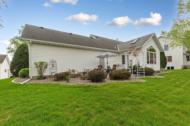 rear view of property featuring a patio area, a yard, roof with shingles, and outdoor lounge area