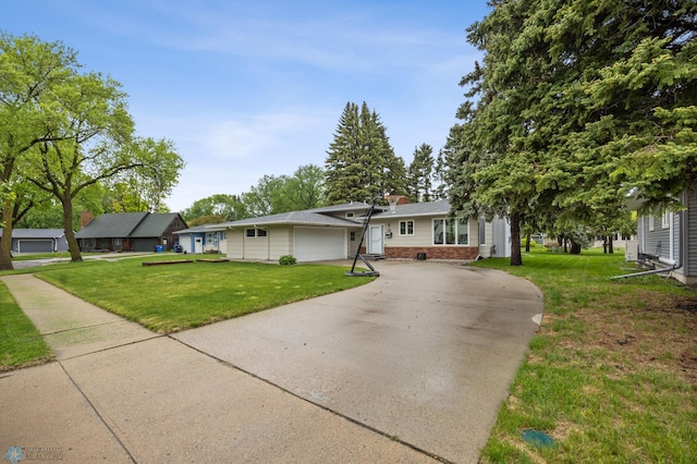 2514 Willow Rd N, Fargo, ND 58102 - view of front facade with brick siding, concrete driveway, a garage, and a front yard
