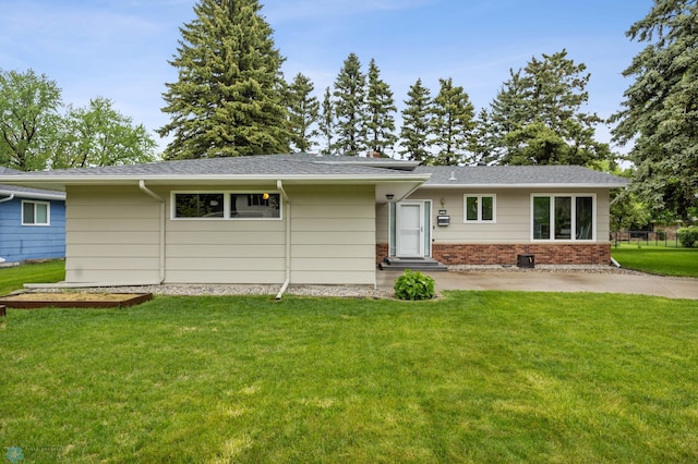 2514 Willow Rd N, Fargo, ND 58102 - ranch-style home with a front yard, entry steps, brick siding, and a patio