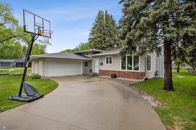 2514 Willow Rd N, Fargo, ND 58102 - split level home featuring a front lawn, brick siding, driveway, and a garage