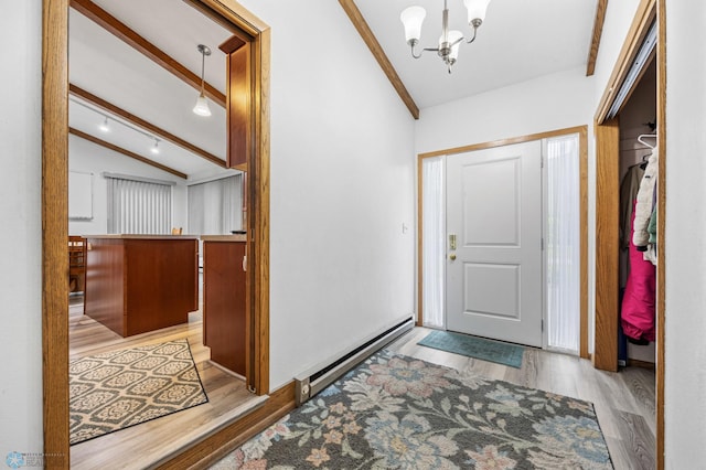 2514 Willow Rd N, Fargo, ND 58102 - entryway with baseboard heating, wood finished floors, and a chandelier