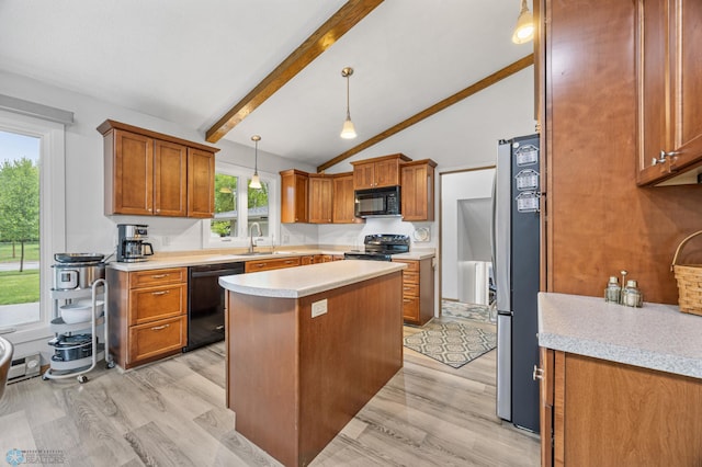 2514 Willow Rd N, Fargo, ND 58102 - kitchen featuring black appliances, light wood-style flooring, light countertops, and a kitchen island