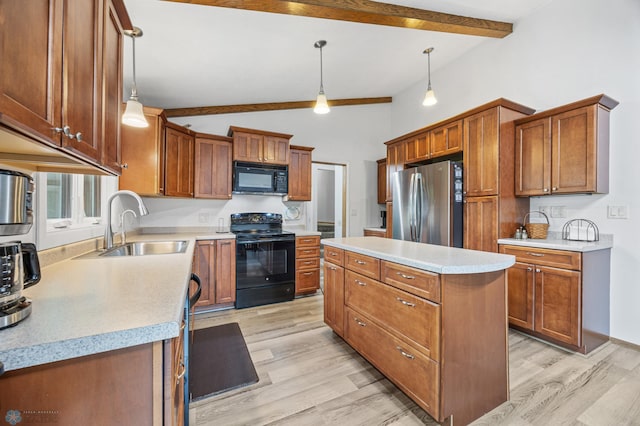 2514 Willow Rd N, Fargo, ND 58102 - kitchen with black appliances, light wood-style floors, a kitchen island, and brown cabinets