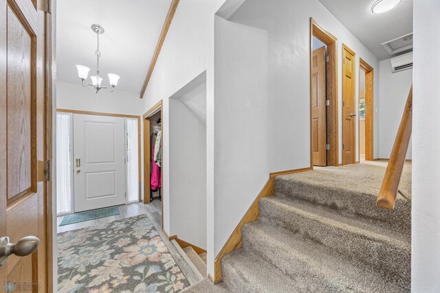 2514 Willow Rd N, Fargo, ND 58102 - entryway featuring an AC wall unit, a chandelier, stairway, baseboards, and wood finished floors