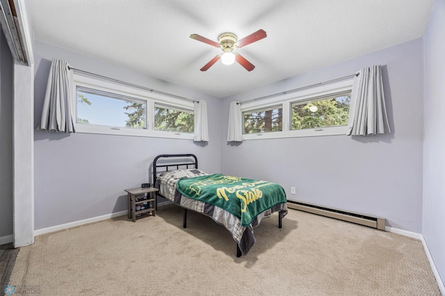 2514 Willow Rd N, Fargo, ND 58102 - carpeted bedroom with a baseboard radiator, baseboards, and a ceiling fan