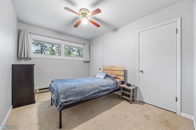 2514 Willow Rd N, Fargo, ND 58102 - bedroom featuring baseboard heating, carpet flooring, a ceiling fan, and baseboards