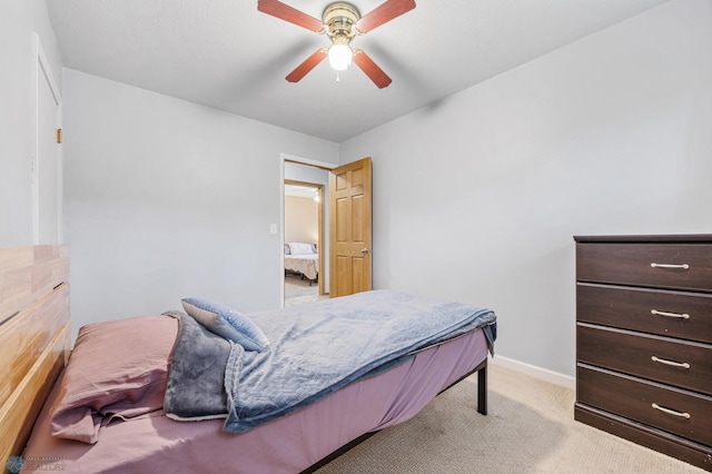2514 Willow Rd N, Fargo, ND 58102 - bedroom featuring light colored carpet, baseboards, and a ceiling fan