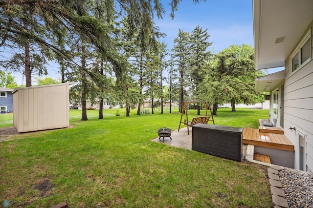 2514 Willow Rd N, Fargo, ND 58102 - view of grassy yard featuring a fire pit and a deck