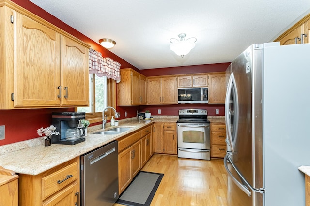4822 3rd St NW, Rochester, MN 55901 - kitchen with stainless steel appliances, a sink, and light wood-style flooring