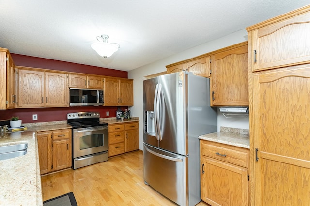 4822 3rd St NW, Rochester, MN 55901 - kitchen with stainless steel appliances, light countertops, light wood-type flooring, and a sink