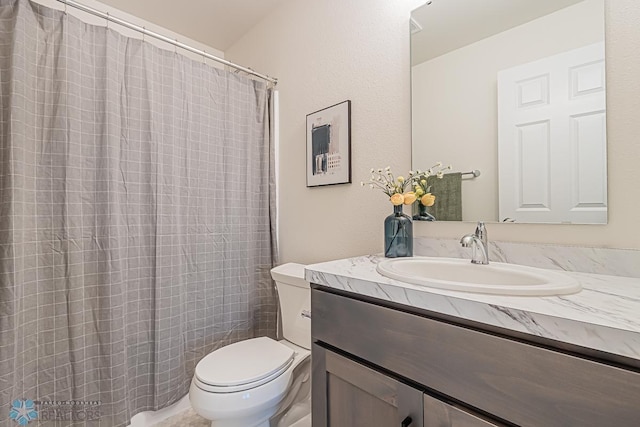 full bathroom with toilet, vanity, and curtained shower