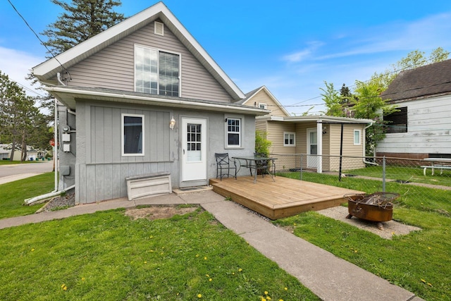 301 3rd St, Nashwauk, MN 55769 - rear view of house featuring a fire pit and a deck