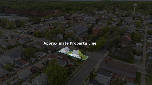 301 3rd St, Nashwauk, MN 55769 - aerial perspective of suburban area featuring a heavily wooded area and property boundaries highlighted
