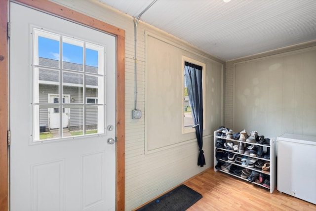 301 3rd St, Nashwauk, MN 55769 - doorway featuring plenty of natural light, wooden walls, and light wood finished floors