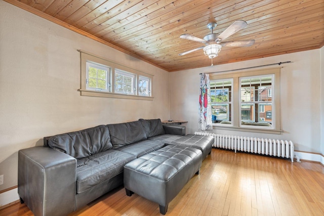 301 3rd St, Nashwauk, MN 55769 - living area featuring radiator, wooden ceiling, crown molding, ceiling fan, and baseboards