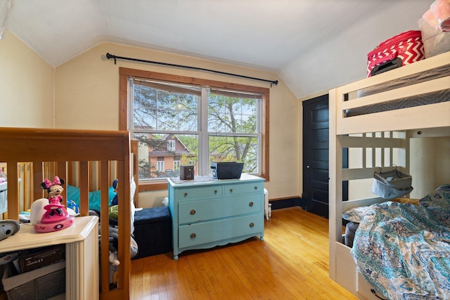 301 3rd St, Nashwauk, MN 55769 - bedroom featuring lofted ceiling and light wood-style flooring