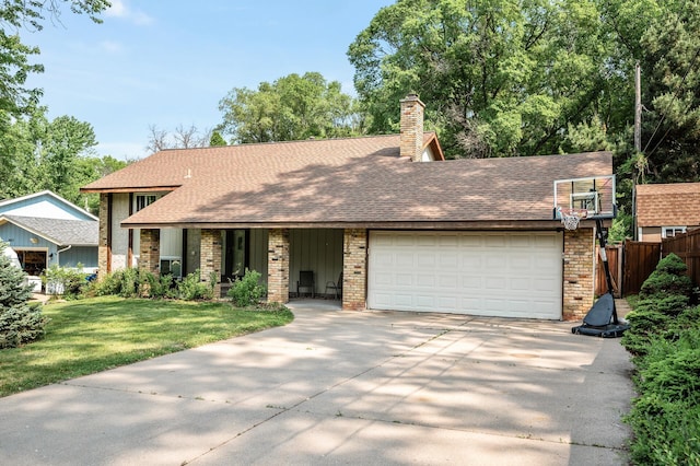 1653 Briardale Rd NE, Fridley, MN 55432 - view of front facade with an attached garage, driveway, a chimney, and brick siding