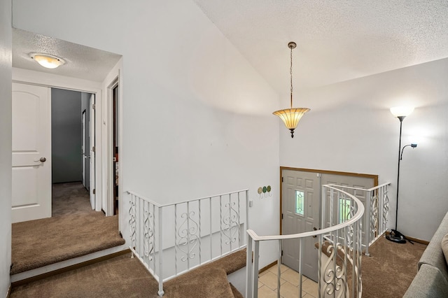 1653 Briardale Rd NE, Fridley, MN 55432 - carpeted entryway featuring a textured ceiling, vaulted ceiling, and baseboards