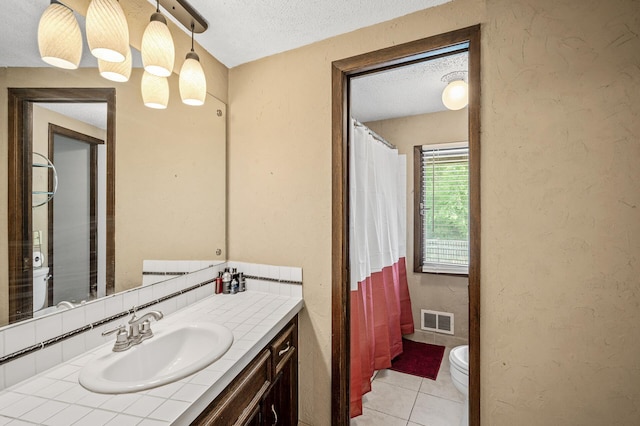 1653 Briardale Rd NE, Fridley, MN 55432 - full bath featuring vanity, a textured wall, toilet, a textured ceiling, and tile patterned flooring