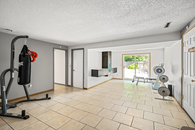 1653 Briardale Rd NE, Fridley, MN 55432 - exercise area featuring a textured ceiling, baseboards, and light tile patterned floors