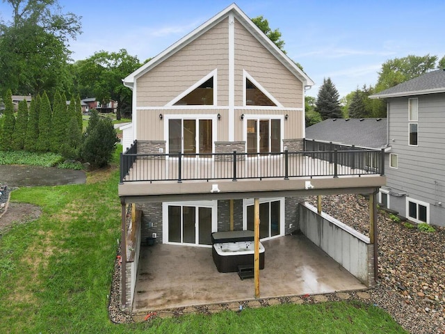 17394 Sunset Trl SW, Prior Lake, MN 55372 - back of house featuring a patio, stone siding, a lawn, board and batten siding, and a wooden deck