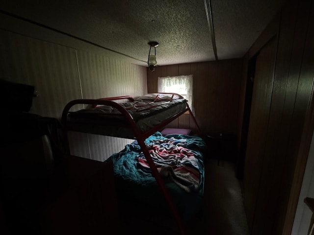 54202 Memory Ln NE, Waskish, MN 56685 - bedroom featuring a textured ceiling and wooden walls