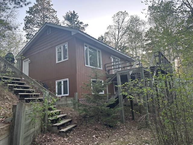view of side of property featuring stairs