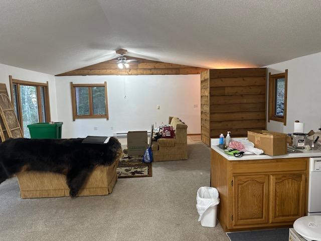 living room with ceiling fan, light carpet, and lofted ceiling