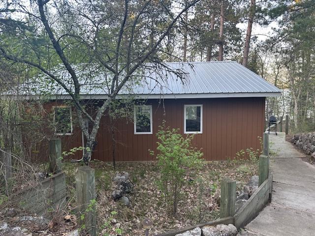 view of side of home featuring metal roof