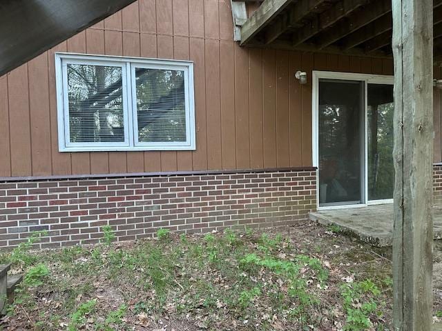 view of side of home with brick siding