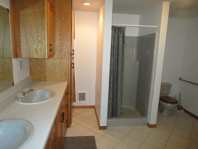 50532 County 29, Bemidji, MN 56601 - bathroom featuring tile patterned floors, a shower stall, toilet, double vanity, and baseboards