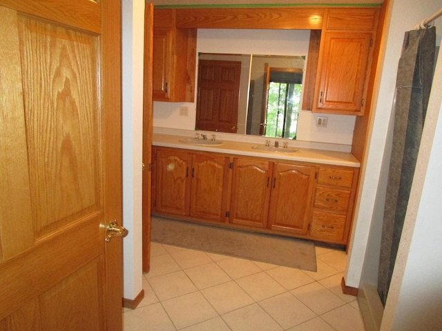 50532 County 29, Bemidji, MN 56601 - kitchen featuring light countertops, a sink, brown cabinetry, and light tile patterned floors