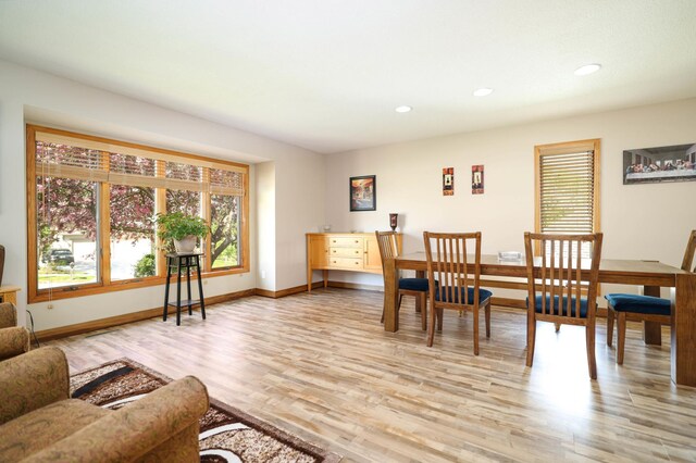 dining area with healthy amount of natural light, light wood-type flooring, baseboards, and recessed lighting