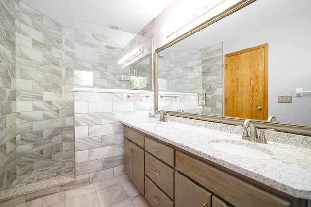 full bathroom featuring walk in shower, double vanity, and marble look tile flooring