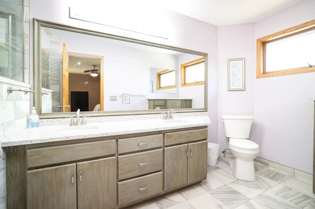 full bathroom featuring toilet and double vanity
