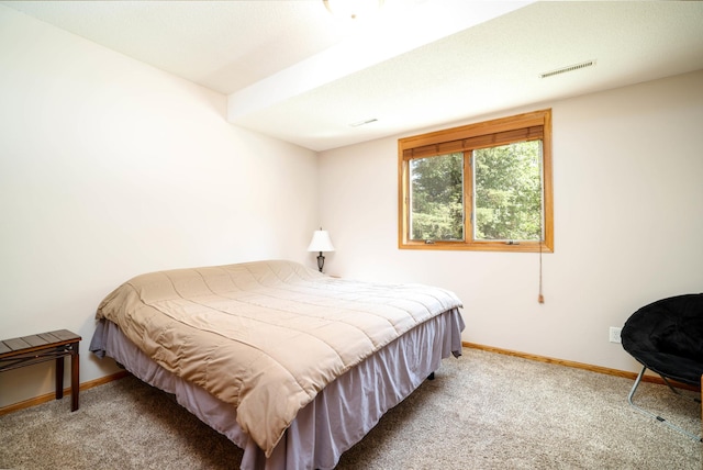 carpeted bedroom featuring baseboards