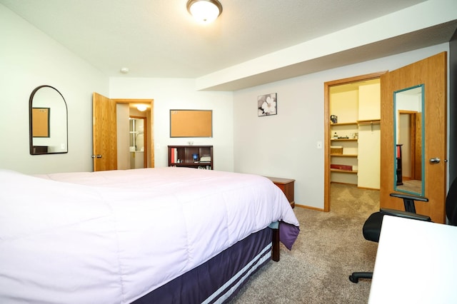 bedroom featuring carpet, a walk in closet, and a closet